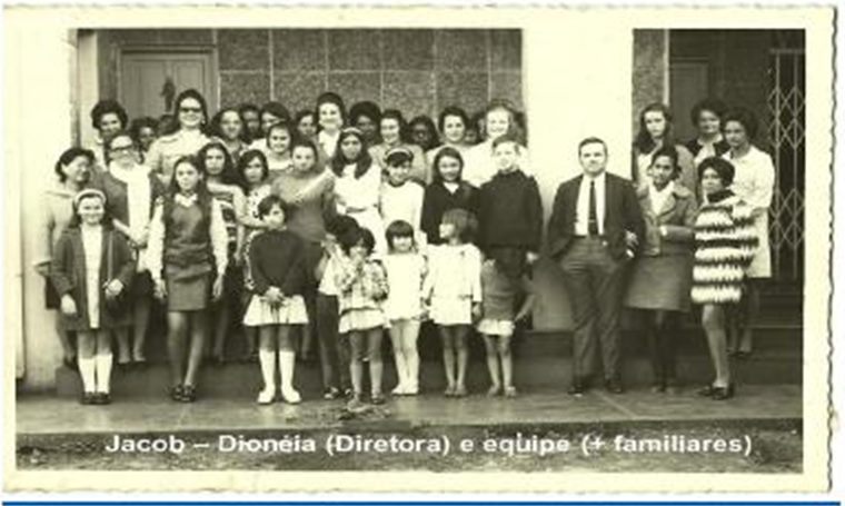 Primeira equipe da Escola Sebastião Paraná reunida diante da instituição